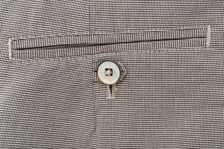 Button on gray pants, closeupの写真素材