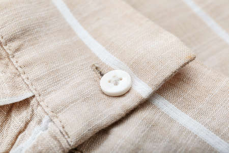 Button on striped shirt, closeupの写真素材