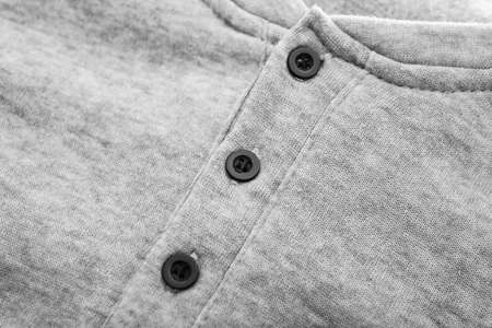 Buttons on gray shirt, closeupの写真素材