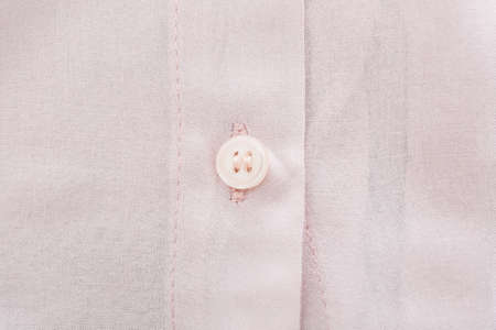 Button on linen shirt, closeup