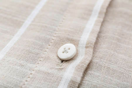 Button on striped shirt, closeupの写真素材