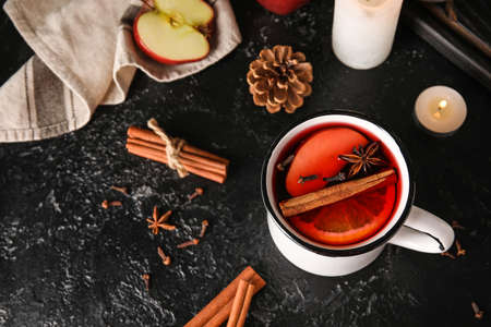 Cup of tasty fruit tea with cinnamon on black backgroundの写真素材