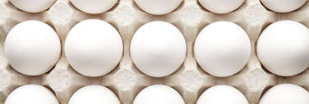 Many fresh raw eggs in box, top view