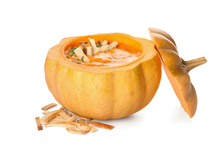 Delicious cream soup served in pumpkin on white backgroundの写真素材