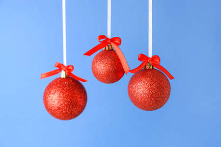 Red Christmas balls on blue background, closeupの写真素材