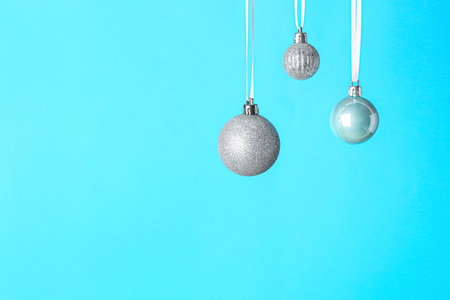 Silver Christmas balls on color backgroundの写真素材