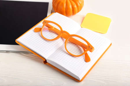Colorful eyeglasses and notebook on light wooden backgroundの写真素材