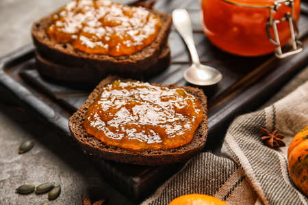 Tasty toasts with sweet pumpkin jam on gray background, closeupの写真素材