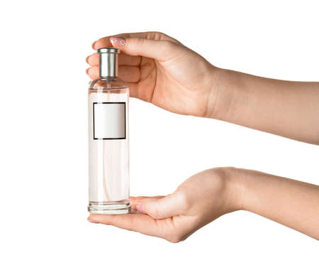 Female hands with bottle of perfume isolated on white background, closeup