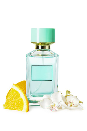 Bottle of perfume, flowers and orange pieces on white backgroundの写真素材