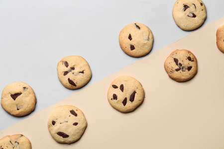 Delicious cookies with chocolate chips on color backgroundの写真素材