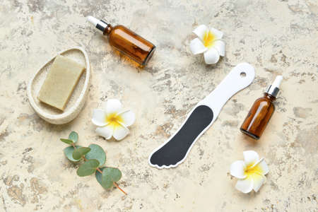 Composition with bath supplies for foot massage and flowers on grunge backgroundの写真素材