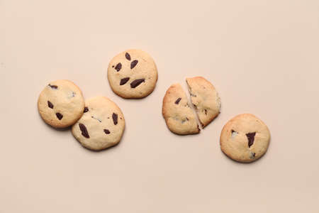 Delicious homemade cookies with chocolate chips on beige background