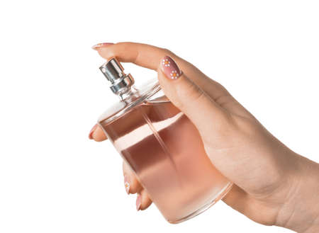 Female hand with perfume bottle on white background, closeup