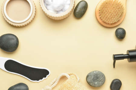 Frame made of supplies for foot massage on color background
