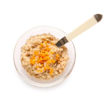 Bowl of tasty oatmeal with pumpkin on white backgroundの写真素材