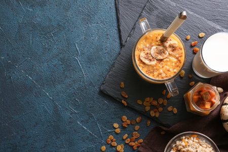 Pot of tasty oatmeal with pumpkin on black backgroundの写真素材