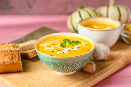 Bowl with delicious pumpkin cream soup on table, closeupの写真素材