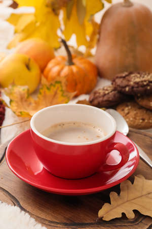 Cup of coffee and autumn decor on wooden board, closeupの写真素材