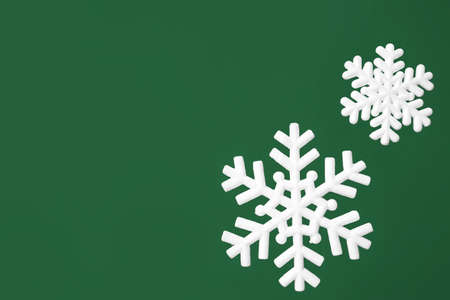 White snowflakes hanging near green wallの写真素材