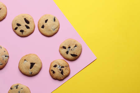 Tasty homemade cookies with chocolate chips on color backgroundの写真素材