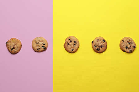 Tasty homemade cookies with chocolate chips on color backgroundの写真素材