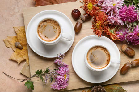 Composition with cups of coffee, flowers ad natural forest decor on color backgroundの写真素材