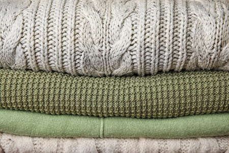 Stack of different warm sweaters as backgroundの写真素材