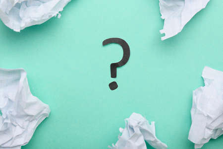 Crumpled paper and question mark on green backgroundの写真素材