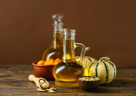 Jugs with pumpkin seed oil on tableの写真素材