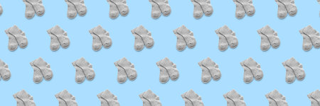 Many baby socks on light blue background. pattern for design