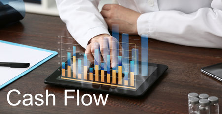 Businessman with tablet computer in office. cash flowの写真素材