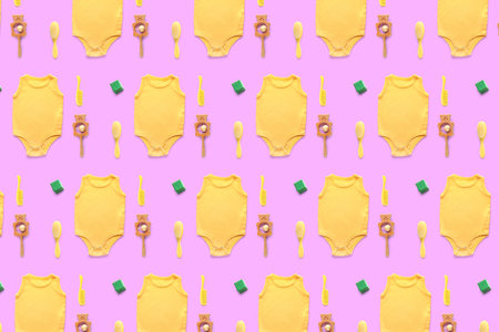 Many baby bodysuits and toys on lilac background. pattern for designの写真素材