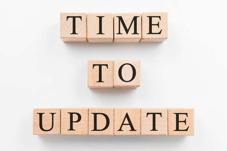 Text TIME TO UPDATE made of wooden cubes on white background