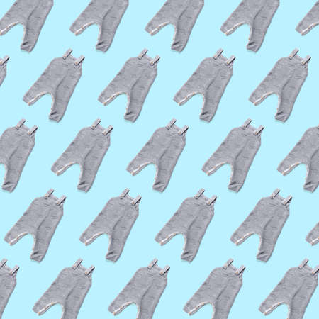 Many baby clothes on light blue background. pattern for designの写真素材
