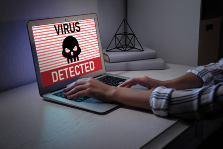 Woman working on laptop at night. antivirus conceptの写真素材