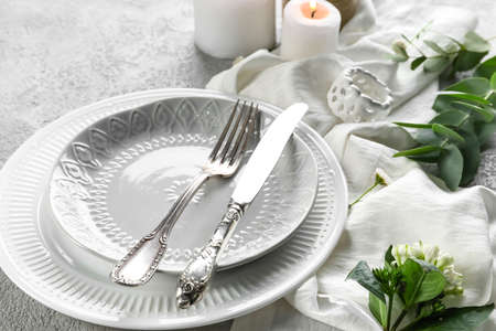 Beautiful table setting for wedding and flowers on gray backgroundの写真素材