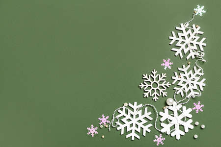 Beautiful snowflakes on green backgroundの写真素材