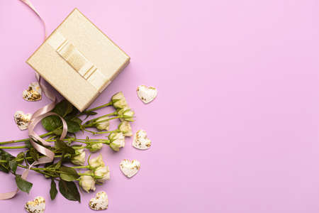 Gift for Valentine's Day and flowers on pink backgroundの写真素材