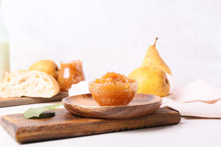 Bowl of delicious pear jam on tableの写真素材