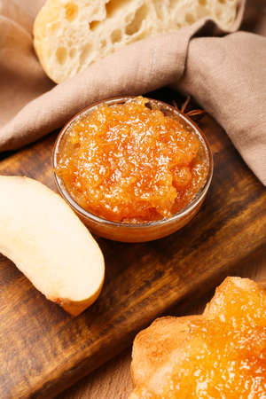 Bowl of tasty pear jam and bread on table, closeupの写真素材