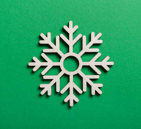 Beautiful snowflake on green backgroundの写真素材