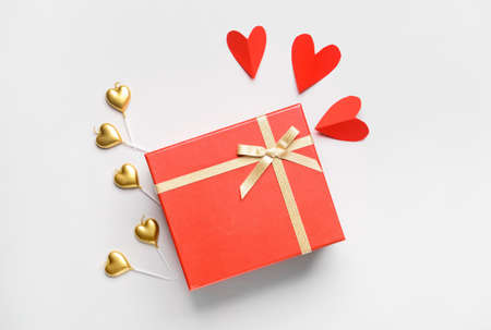 Gift for Valentine's Day and hearts on white background