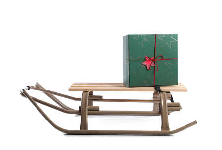 Sled with Christmas gift on white backgroundの写真素材