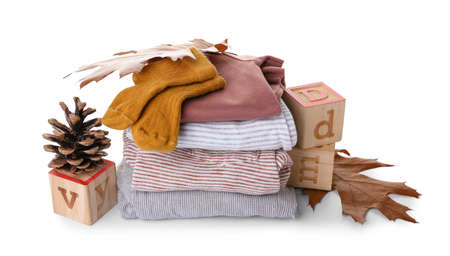 Stack of baby clothes, toys and natural decor on white backgroundの写真素材