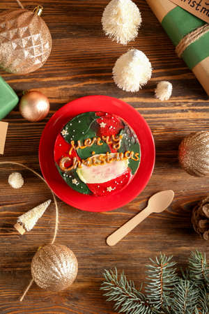 Christmas composition with tasty bento cake in plate on wooden backgroundの写真素材