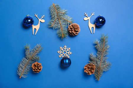 Christmas composition with decor, balls and fir branches on blue backgroundの写真素材