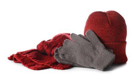 Stylish warm hat, gloves and scarf on white backgroundの写真素材