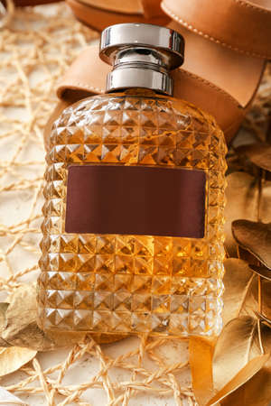 Perfume bottle, plant branch and shoes on table, closeupの写真素材