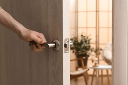 Man opening door at home, closeupの写真素材
